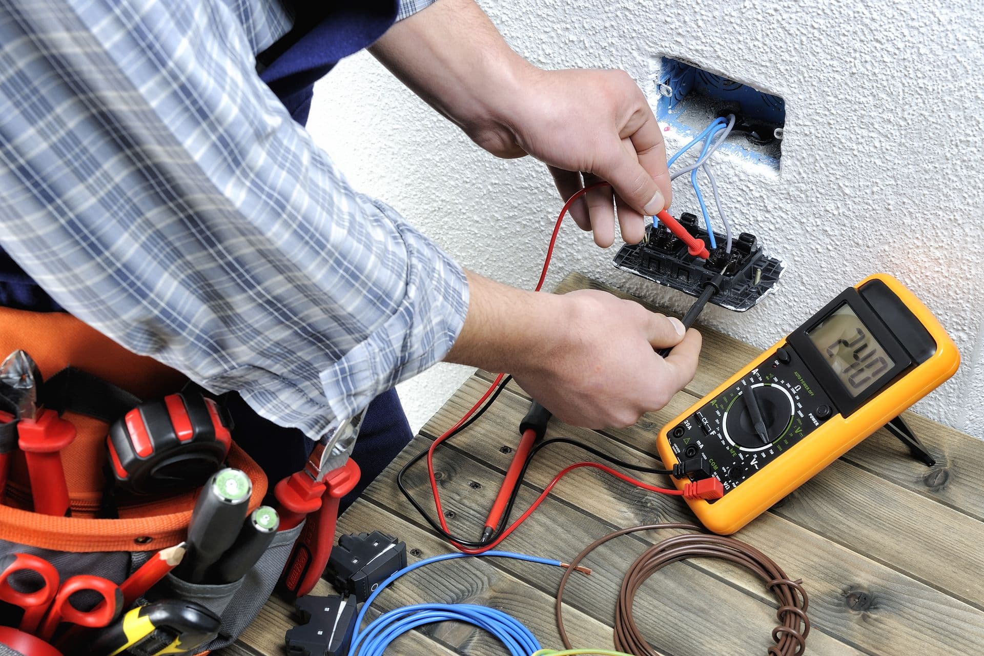 Electrician at work on switches and sockets of a residential electrical installation.